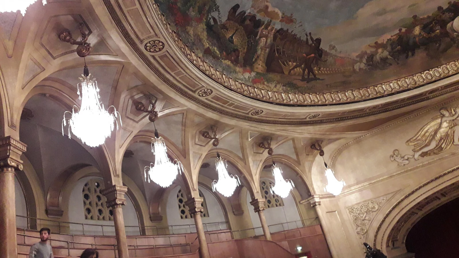 The red-carpeted marble staircase of a grand Roman opera house foyer before a performance, rome opera dress code