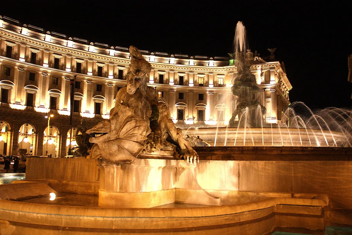 The Fountain of the Naiads on Piazza della Repubblica at night, rome opera dress code